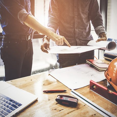 Two Architect man working with compasses and blueprints for architectural plan,engineer sketching a construction project concept.